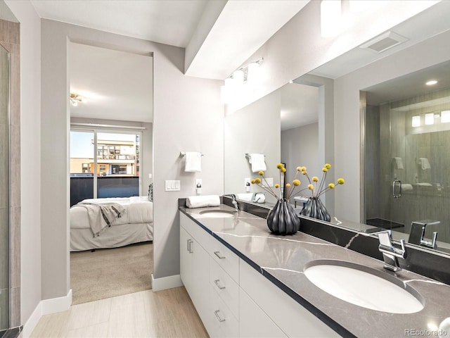 bathroom featuring vanity and an enclosed shower