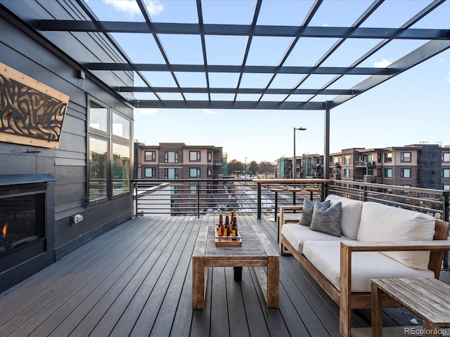 wooden deck with a pergola and an outdoor hangout area