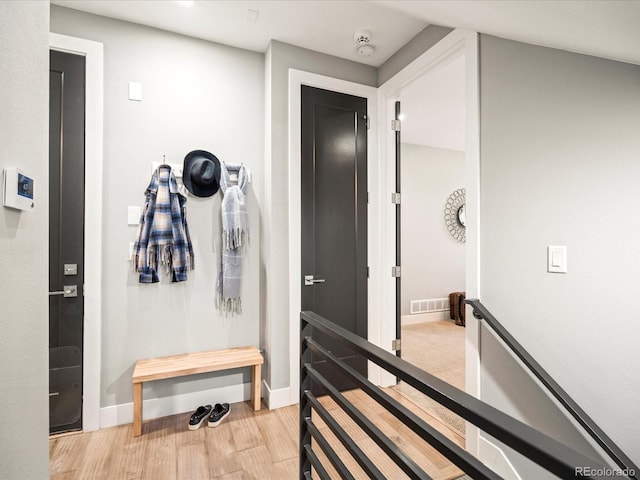 mudroom with visible vents, light wood-style flooring, and baseboards