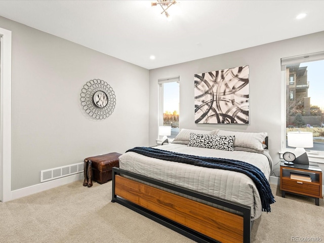 carpeted bedroom featuring baseboards, visible vents, and recessed lighting