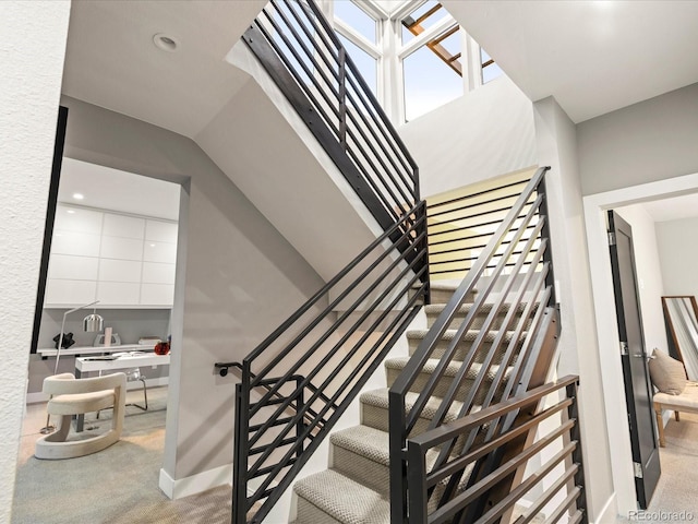 stairway with recessed lighting, carpet flooring, and baseboards