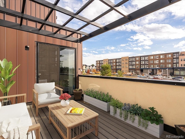 balcony with an outdoor living space and a pergola