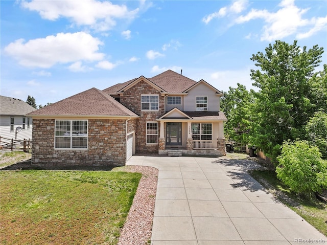 12404 Pine Valley Cir, Peyton, CO 80831 - view of front of property with driveway, an attached garage, a porch, roof with shingles, and stone siding