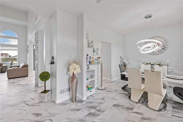 12404 Pine Valley Cir, Peyton, CO 80831 - dining space featuring marble look tile flooring and a chandelier