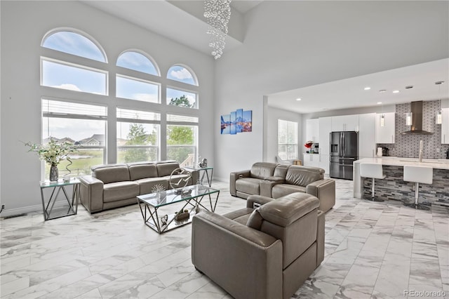 12404 Pine Valley Cir, Peyton, CO 80831 - living room featuring light marble finish floors, a high ceiling, and recessed lighting