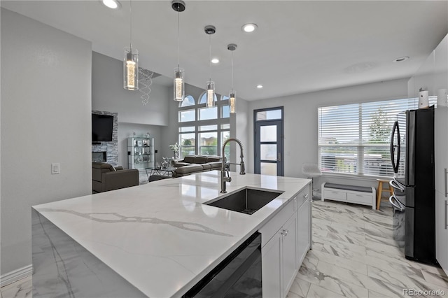 12404 Pine Valley Cir, Peyton, CO 80831 - kitchen featuring freestanding refrigerator, dishwashing machine, light marble finish floors, plenty of natural light, and recessed lighting