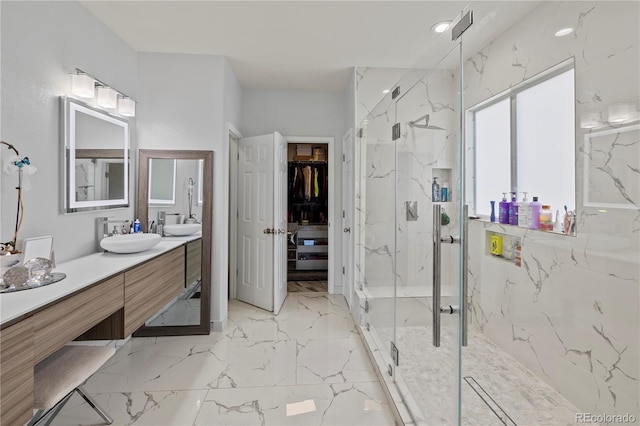 12404 Pine Valley Cir, Peyton, CO 80831 - bathroom featuring a marble finish shower, vanity, marble finish floors, and a spacious closet