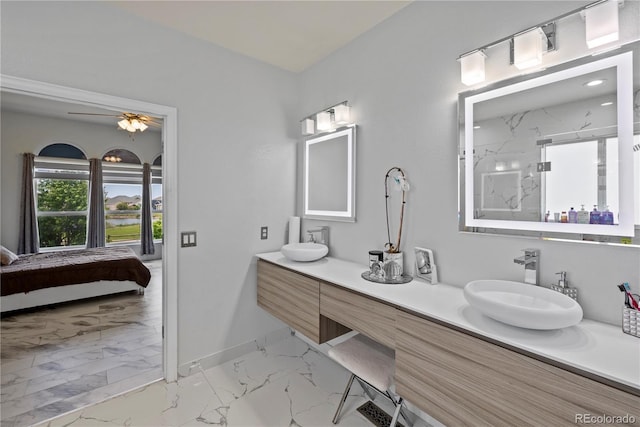 12404 Pine Valley Cir, Peyton, CO 80831 - ensuite bathroom featuring marble finish floors, double vanity, a marble finish shower, and a ceiling fan