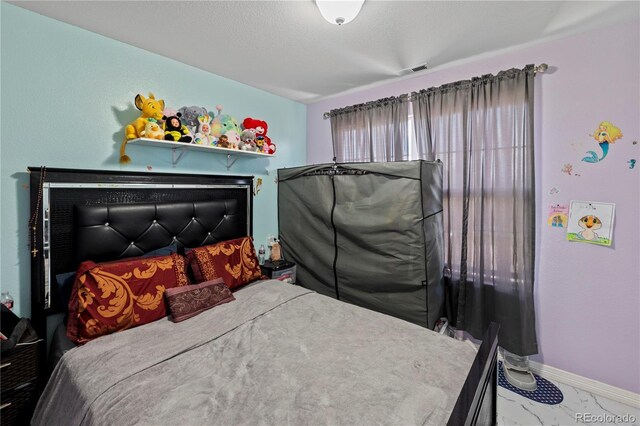 12404 Pine Valley Cir, Peyton, CO 80831 - bedroom featuring marble look tiles and baseboards