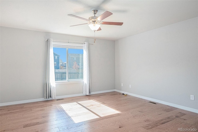 empty room with light hardwood / wood-style flooring and ceiling fan