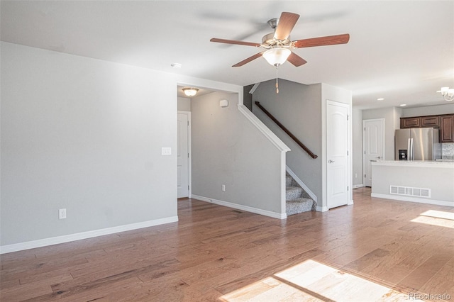 empty room with ceiling fan and wood-type flooring