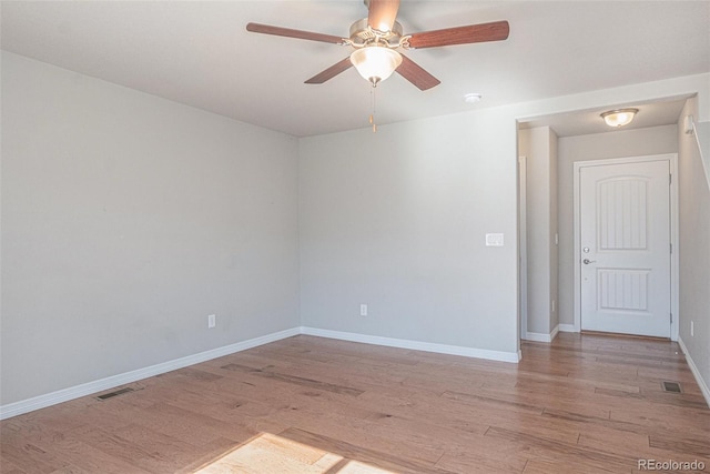 empty room featuring ceiling fan and light hardwood / wood-style floors