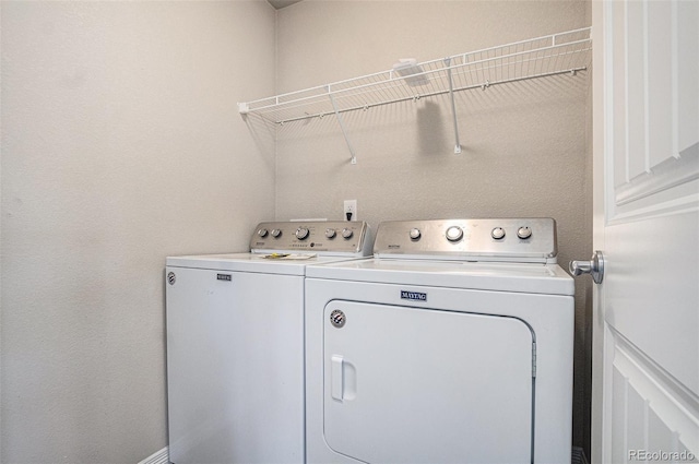 laundry room featuring washing machine and clothes dryer