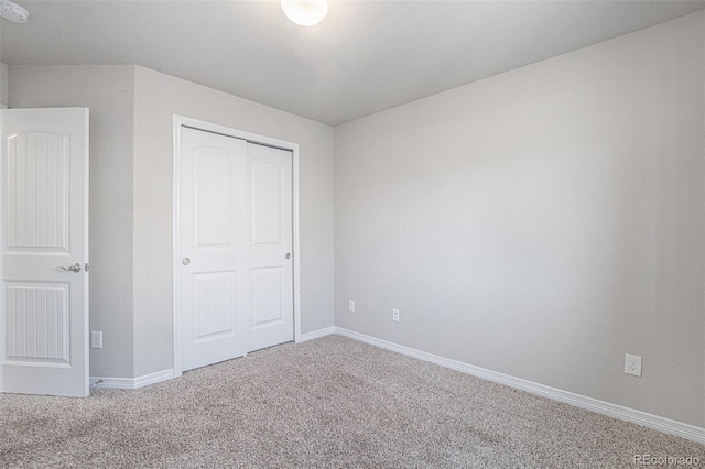 unfurnished bedroom featuring carpet floors and a closet