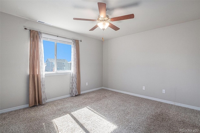 carpeted spare room featuring ceiling fan