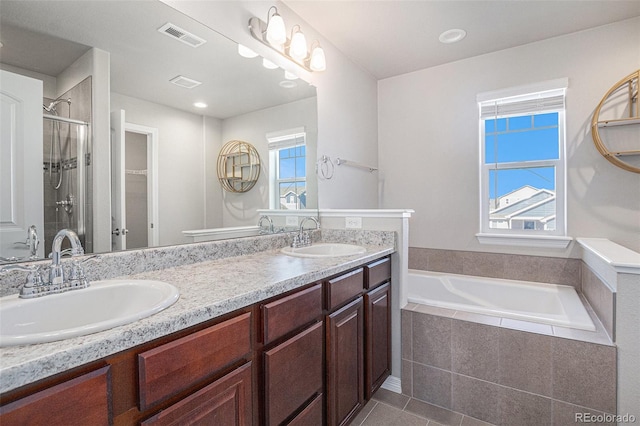 bathroom with tile patterned flooring, vanity, and separate shower and tub