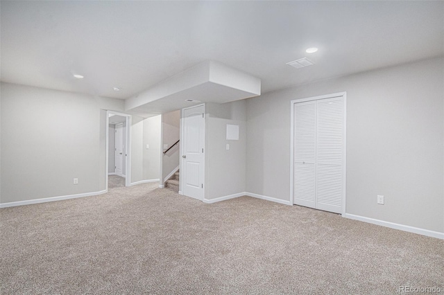 basement featuring light carpet