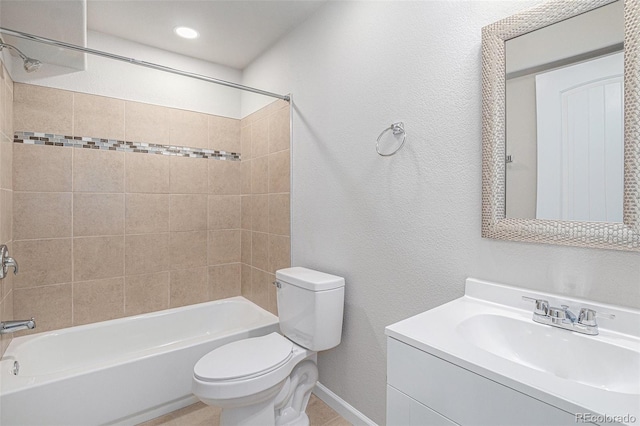 full bathroom featuring vanity, tiled shower / bath combo, toilet, and tile patterned flooring