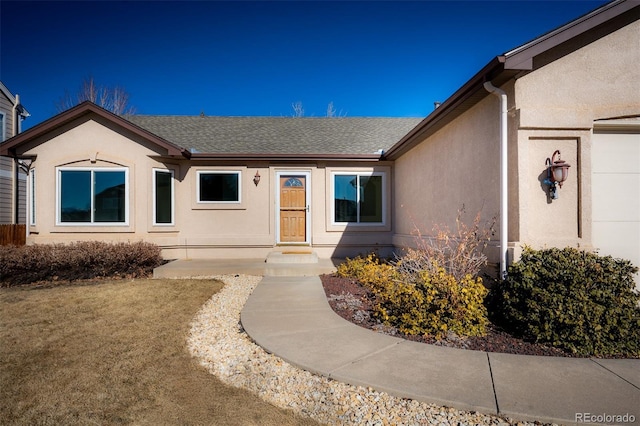 view of exterior entry with a lawn