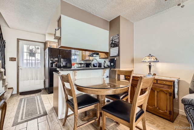 dining room with sink and a textured ceiling