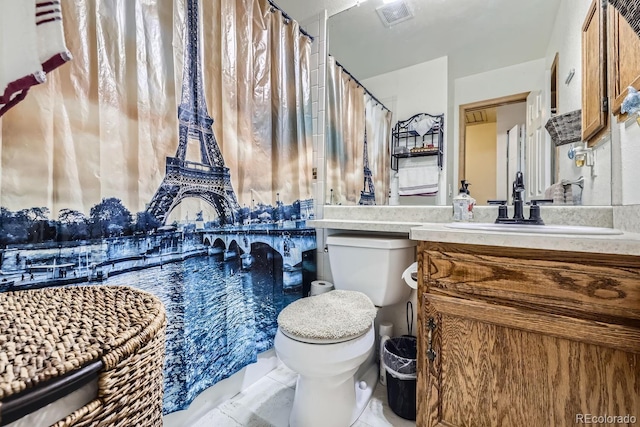 bathroom with tile patterned floors, toilet, and vanity