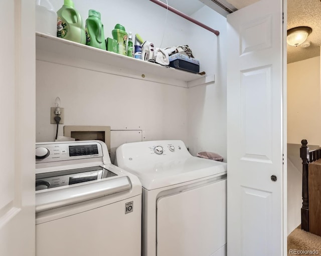 laundry area featuring independent washer and dryer and a textured ceiling