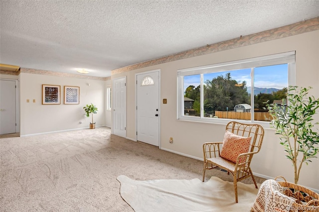 living area with light carpet and a textured ceiling