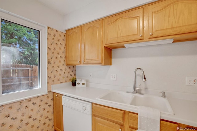 kitchen featuring sink, light brown cabinets, and white dishwasher