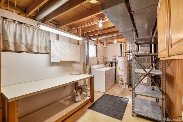 washroom with water heater and washer and dryer