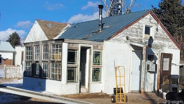 back of property featuring a sunroom