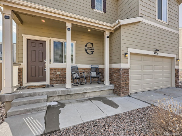 property entrance featuring covered porch and a garage