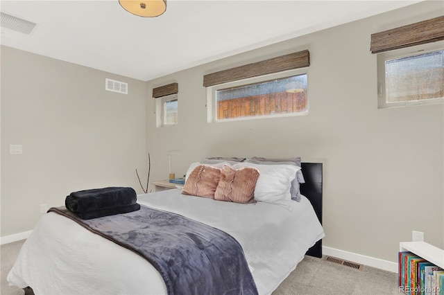 bedroom with carpet, visible vents, and baseboards