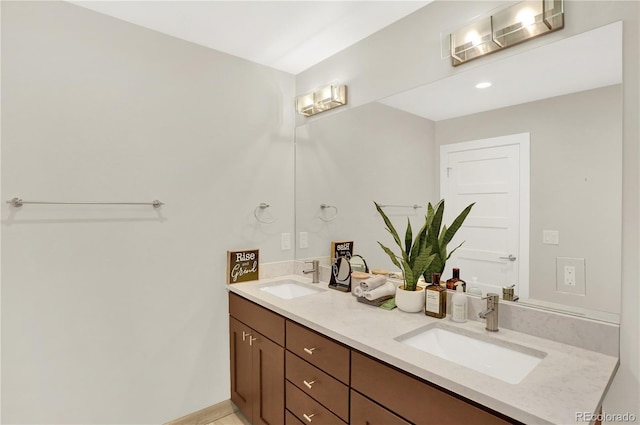 bathroom with a sink and double vanity