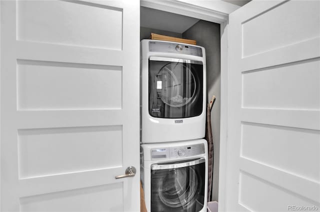 washroom featuring laundry area and stacked washer and dryer