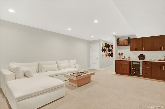 living area with beverage cooler, baseboards, recessed lighting, indoor wet bar, and light carpet