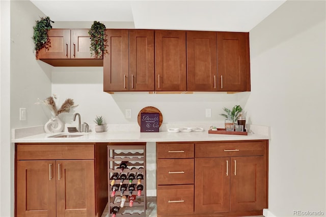 bar featuring a sink and beverage cooler