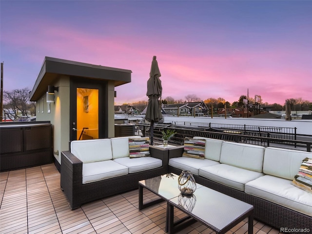 deck at dusk with an outdoor hangout area