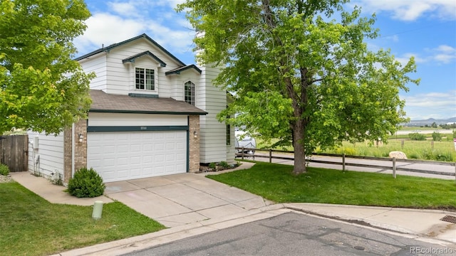 8544 S Upham Way, Littleton, CO 80128 - view of front of home with driveway, a garage, brick siding, and a shingled roof