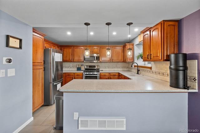 8544 S Upham Way, Littleton, CO 80128 - kitchen featuring appliances with stainless steel finishes, a peninsula, tasteful backsplash, light countertops, and recessed lighting