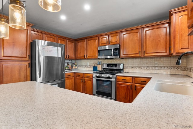 8544 S Upham Way, Littleton, CO 80128 - kitchen featuring appliances with stainless steel finishes, light countertops, brown cabinetry, decorative backsplash, and recessed lighting