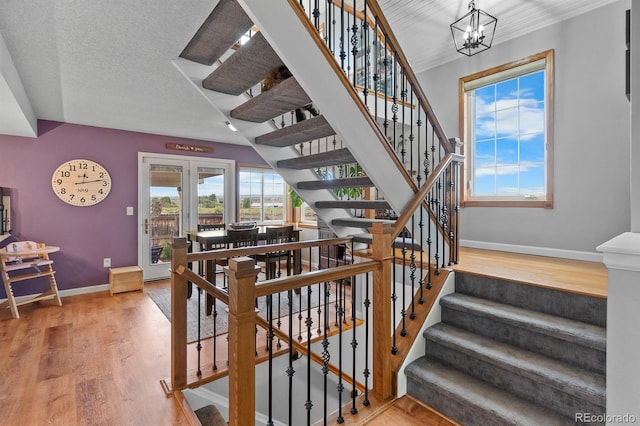 8544 S Upham Way, Littleton, CO 80128 - stairs with wood finished floors and a chandelier