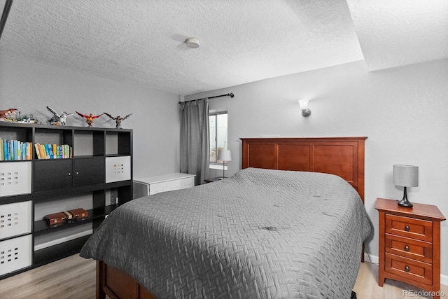 8544 S Upham Way, Littleton, CO 80128 - bedroom featuring light wood finished floors and a textured ceiling