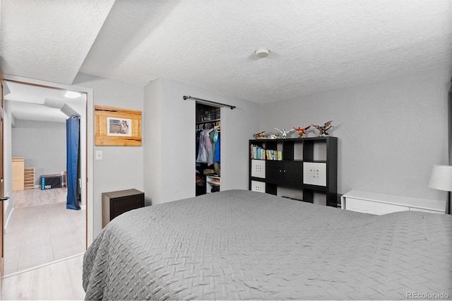 8544 S Upham Way, Littleton, CO 80128 - bedroom with a textured ceiling, a closet, and a walk in closet