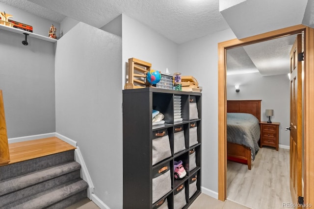 8544 S Upham Way, Littleton, CO 80128 - stairway featuring a textured ceiling and wood finished floors