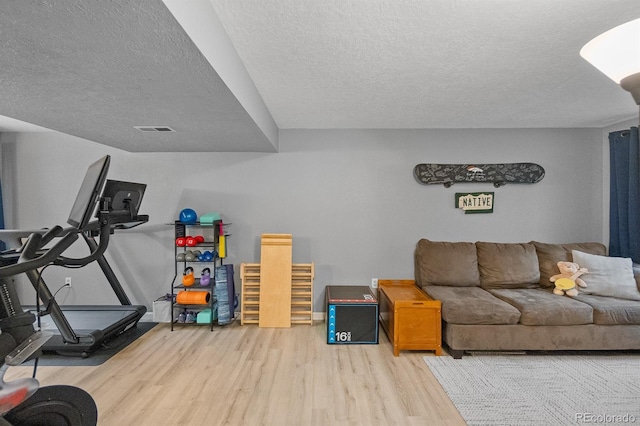 8544 S Upham Way, Littleton, CO 80128 - living room with wood finished floors and a textured ceiling