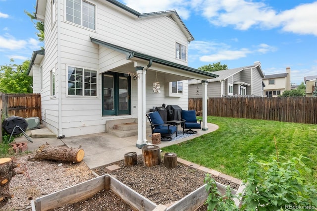 8544 S Upham Way, Littleton, CO 80128 - rear view of house with a patio area and a fenced backyard