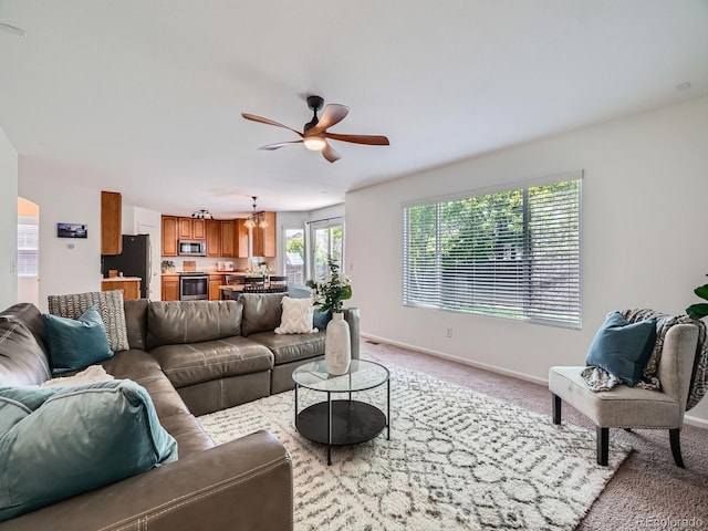 12653 Jersey Cir E, Thornton, CO 80602 - carpeted living area featuring a ceiling fan and baseboards