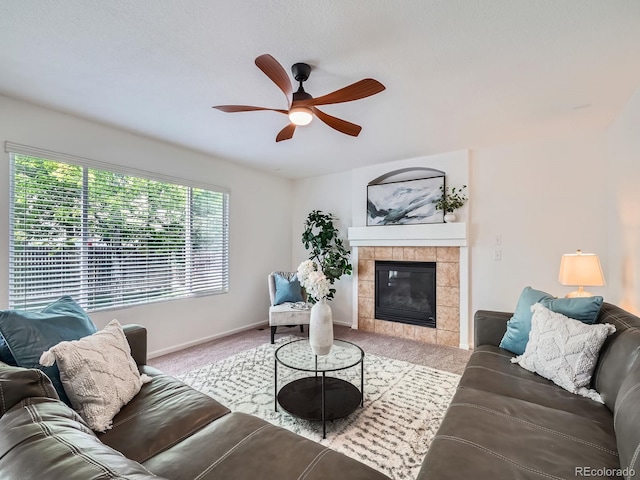 12653 Jersey Cir E, Thornton, CO 80602 - living room with carpet floors, ceiling fan, a tile fireplace, and baseboards