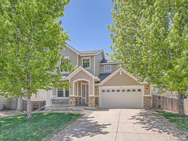 12653 Jersey Cir E, Thornton, CO 80602 - view of front of property with driveway, covered porch, stone siding, a garage, and a shingled roof