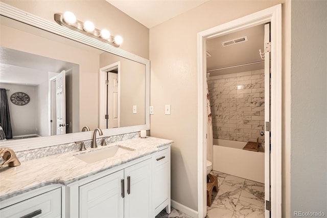 10872 W Evans Ave Unit 3D, Lakewood, CO 80227 - full bathroom with marble look tiles, vanity, toilet, baseboards, and shower / bath combo with shower curtain